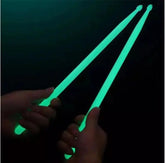 Colorful fluorescent drum sticks from Drum Addict Apparel by Yggdrasils Wood, shown in vibrant blue with bright, eye-catching design.
