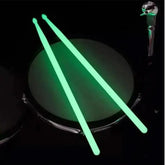 Colorful fluorescent drum sticks from Drum Addict Apparel by Yggdrasils Wood, featuring vibrant blue and multicolor design.