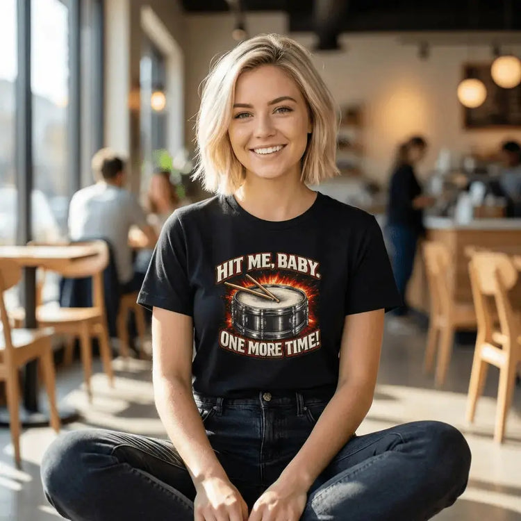 Black Drummer Tee T-shirt with drum graphic and "Hit Me, Baby, One More Time" text, featuring a bold printify drum design.